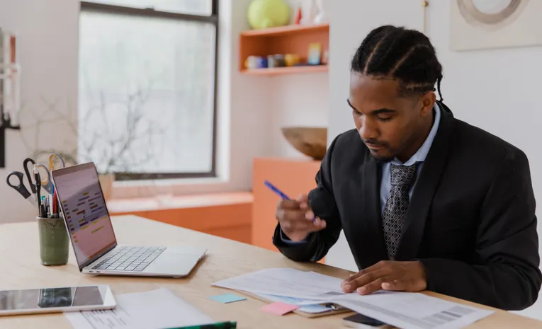 Businessman reviewing documents and data in an office
