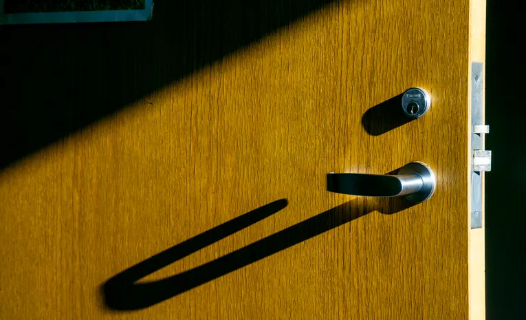 Metal door knob on a wooden door
