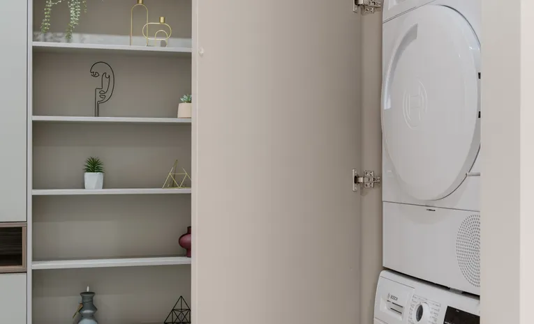Washing machine and tumble dryer in a modern laundry cabinet